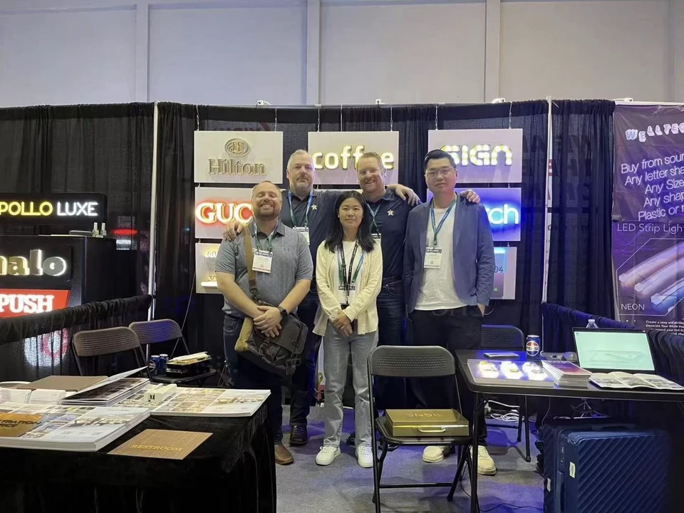 Jayu team meeting visitors at a signage exhibition